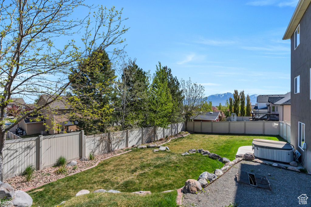 View of yard with a fenced backyard and a mountain view