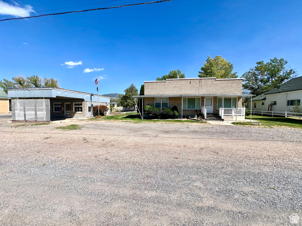 View of front of home with an attached carport and a porch