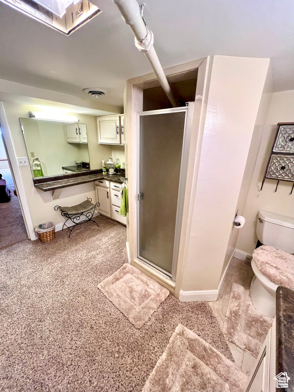 Bathroom featuring baseboards, visible vents, toilet, and a shower stall
