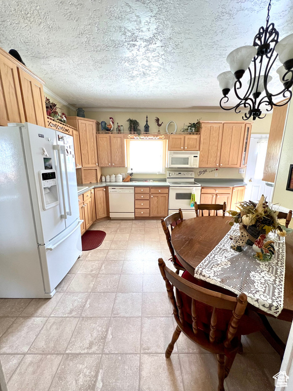 Kitchen featuring light countertops, white appliances, an inviting chandelier, a textured ceiling, and light brown cabinets
