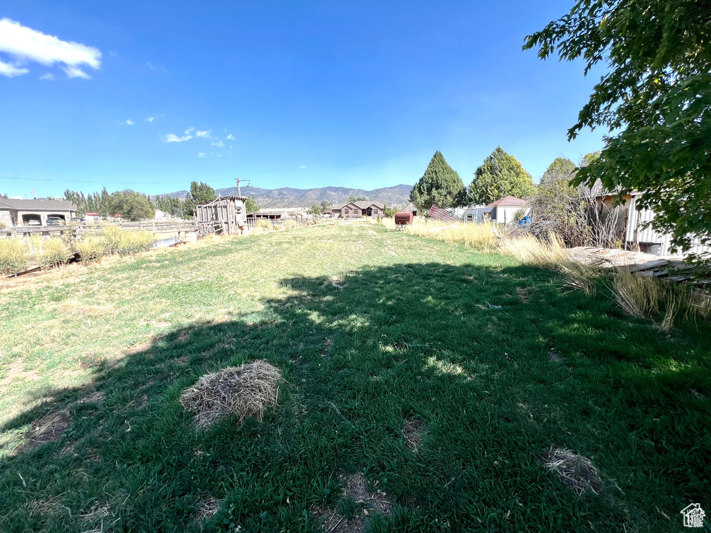 View of yard featuring a mountain view, fence, and a rural view