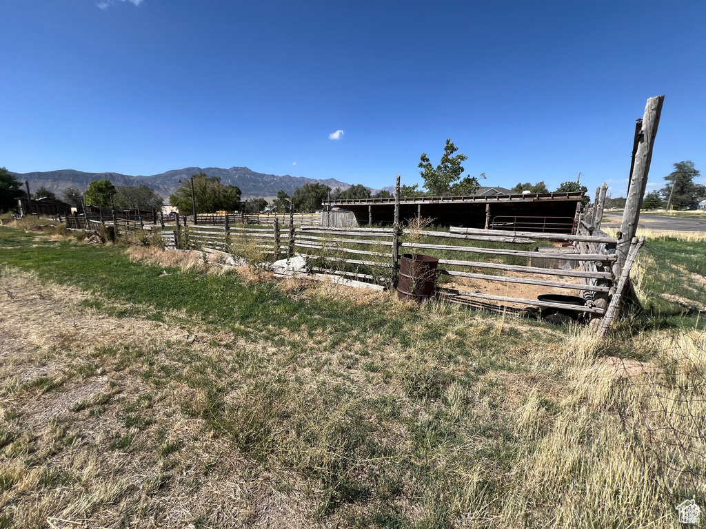 View of horse barn with a mountain view and a rural view