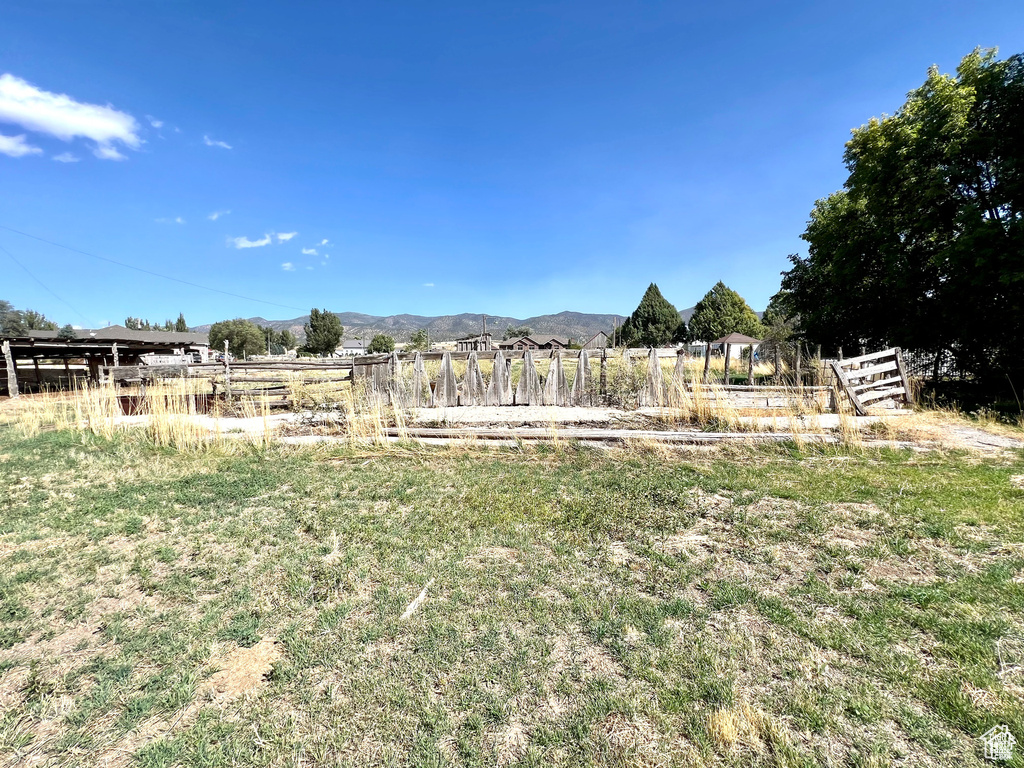 View of yard featuring a rural view and a mountain view