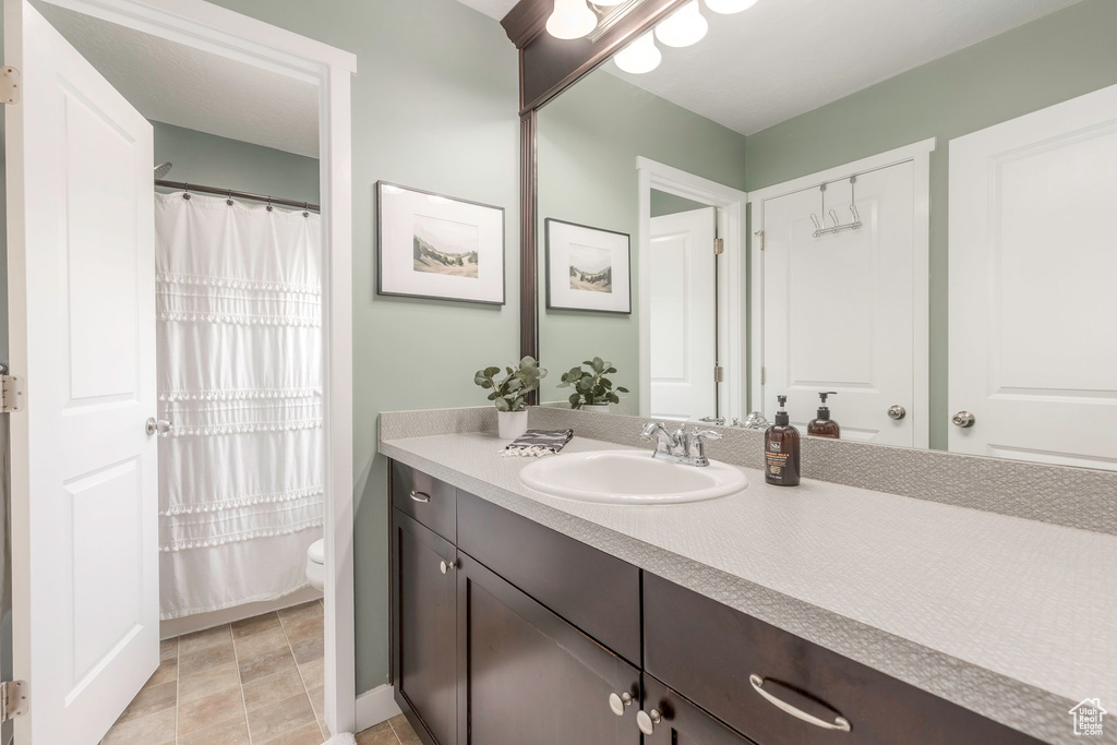 Full bathroom with toilet and vanity