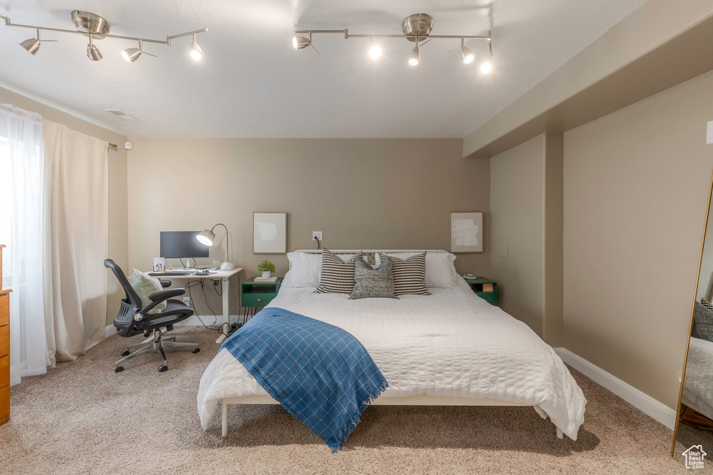 Carpeted bedroom featuring baseboards