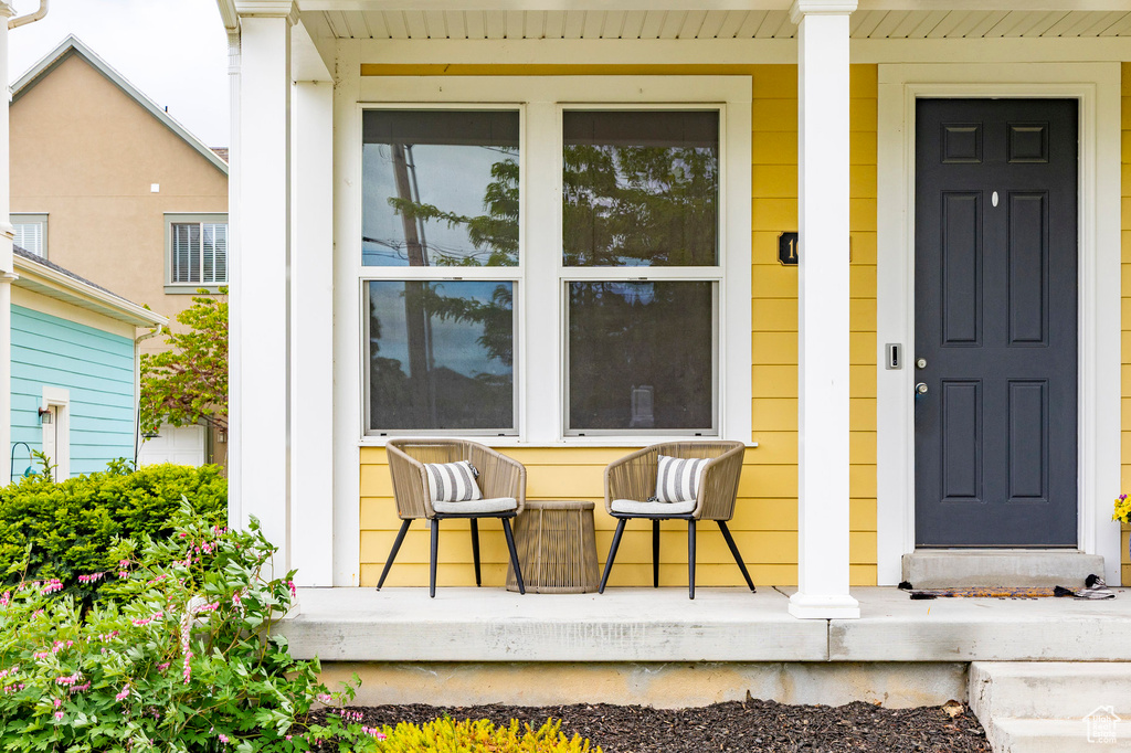 View of exterior entry featuring covered porch