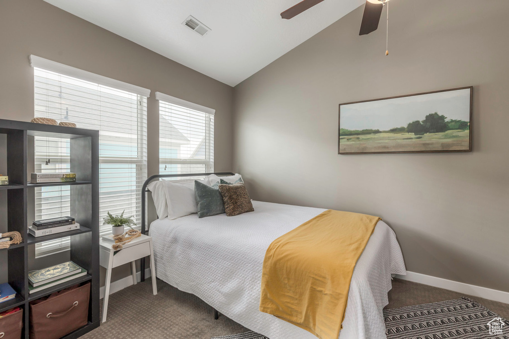 Bedroom featuring carpet flooring, baseboards, lofted ceiling, and visible vents