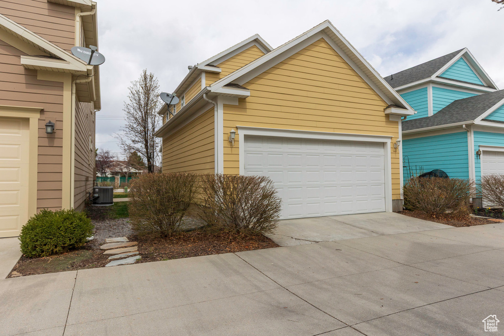Exterior space with cooling unit and a garage
