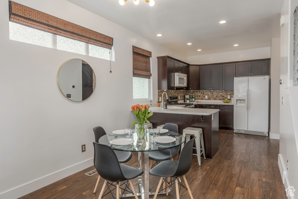 Dining space featuring baseboards, visible vents, recessed lighting, and dark wood-type flooring