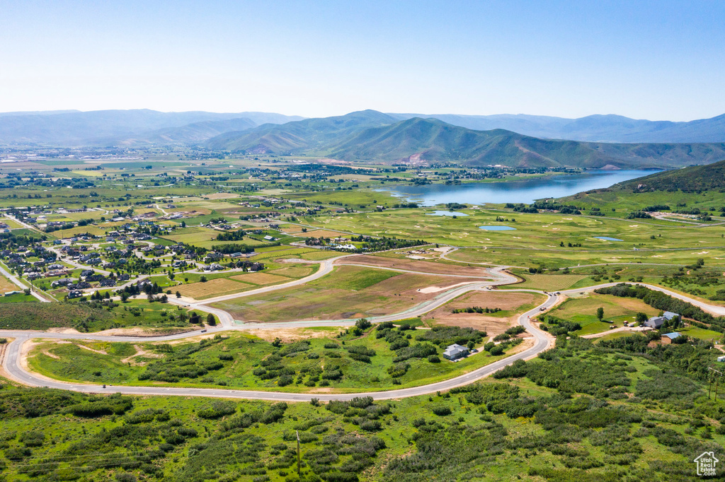 Birds eye view of property with a water and mountain view