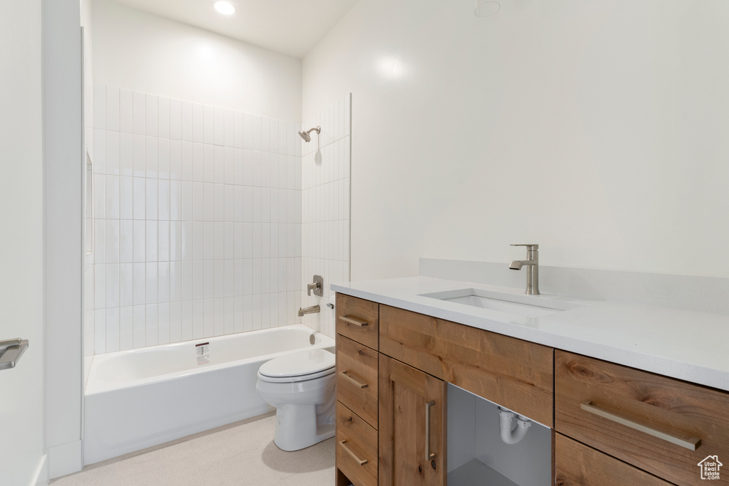 Full bathroom featuring toilet, vanity, and tub / shower combination