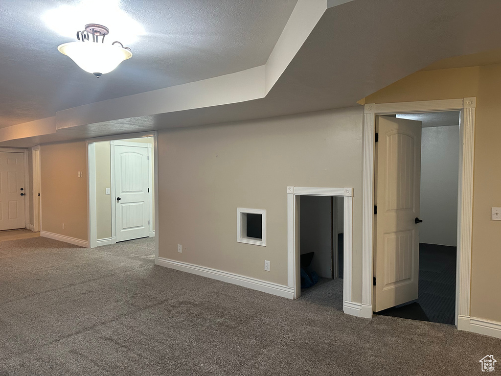 Finished below grade area featuring baseboards and carpet flooring