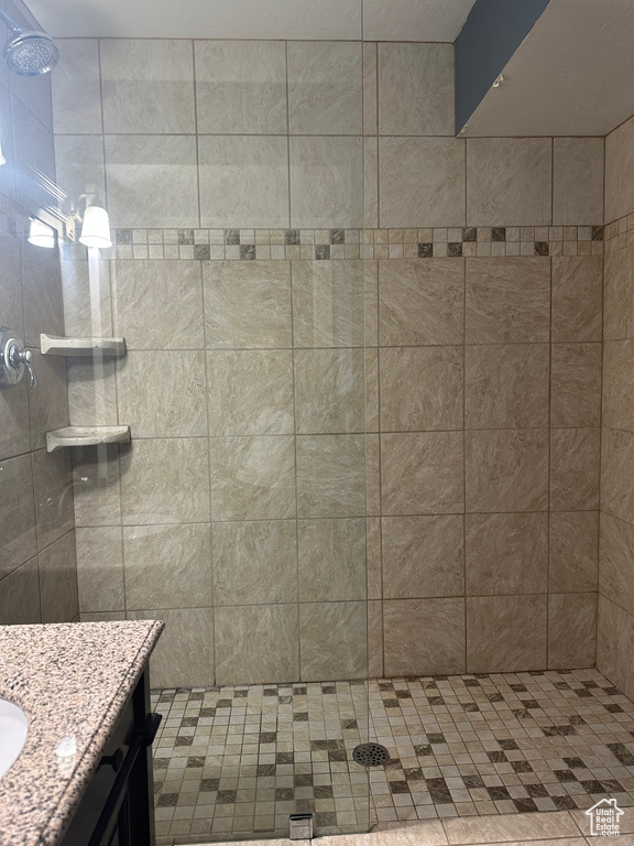 Bathroom with vanity and tiled shower