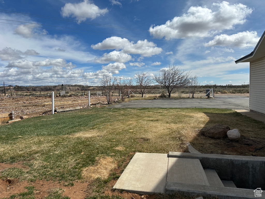 View of yard with a rural view