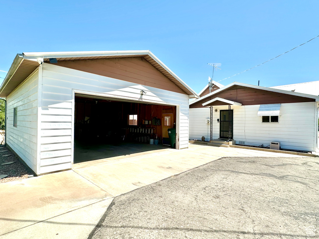 View of front of property featuring a garage, an outbuilding, and entry steps