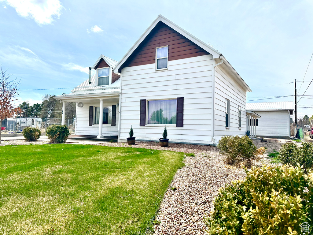 Bungalow with a porch and a front yard