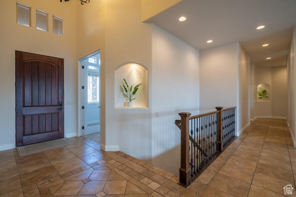 Entrance foyer with recessed lighting, tile patterned flooring, and baseboards