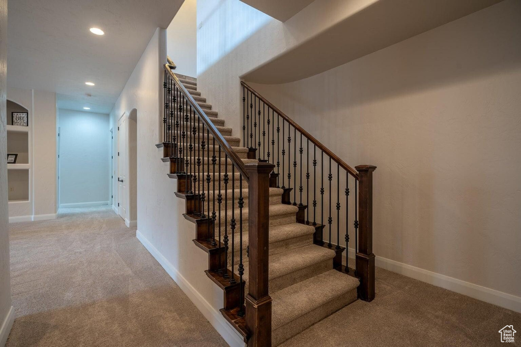 Staircase featuring recessed lighting, carpet, and baseboards