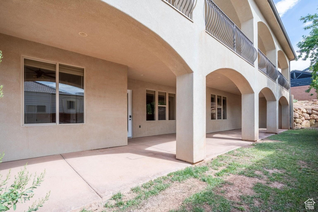 Exterior space featuring a patio, a balcony, and stucco siding