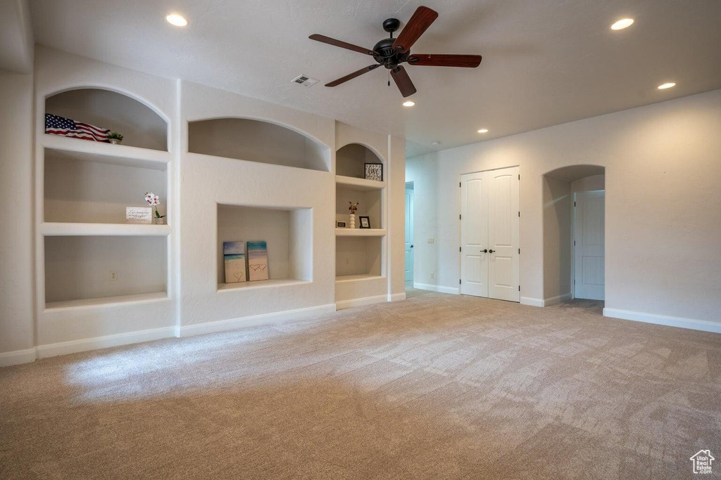 Empty room with light carpet, baseboards, built in features, and recessed lighting