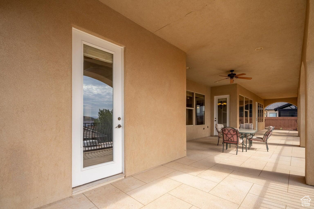 View of patio with outdoor dining area and a ceiling fan