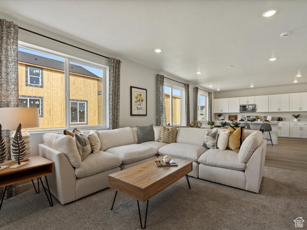 Living room with recessed lighting and light wood finished floors