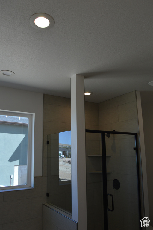 Full bathroom with a stall shower and recessed lighting