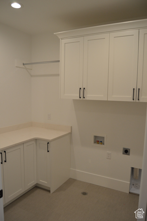 Laundry area with hookup for an electric dryer, cabinet space, hookup for a washing machine, and recessed lighting