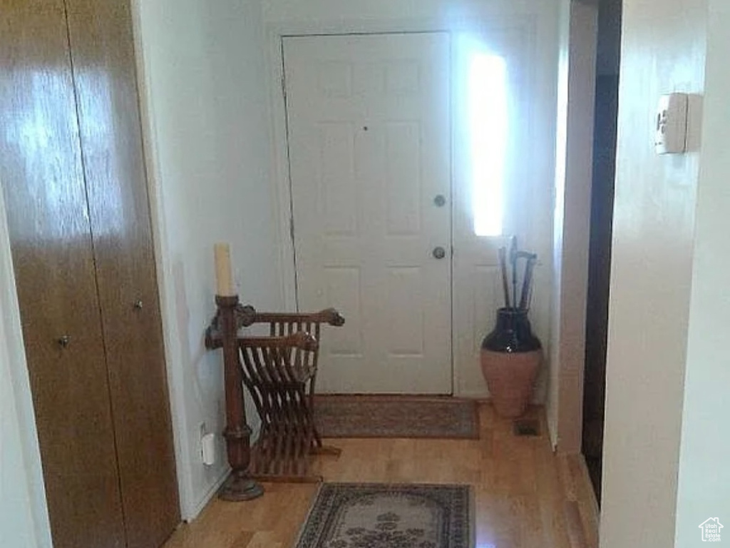 Entrance foyer featuring baseboards and wood finished floors