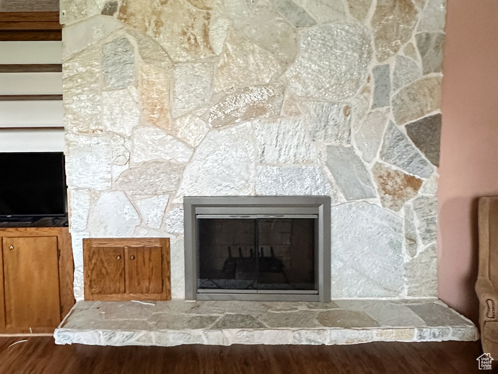 Interior details with a fireplace, wood finished floors, and a textured ceiling