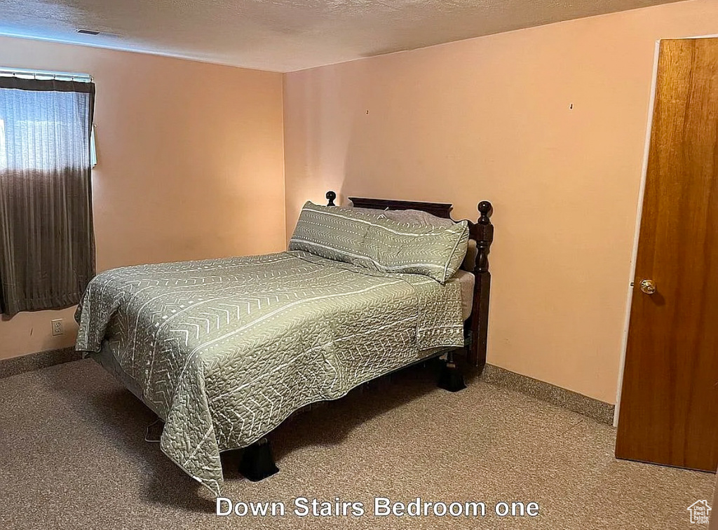 Carpeted bedroom featuring baseboards