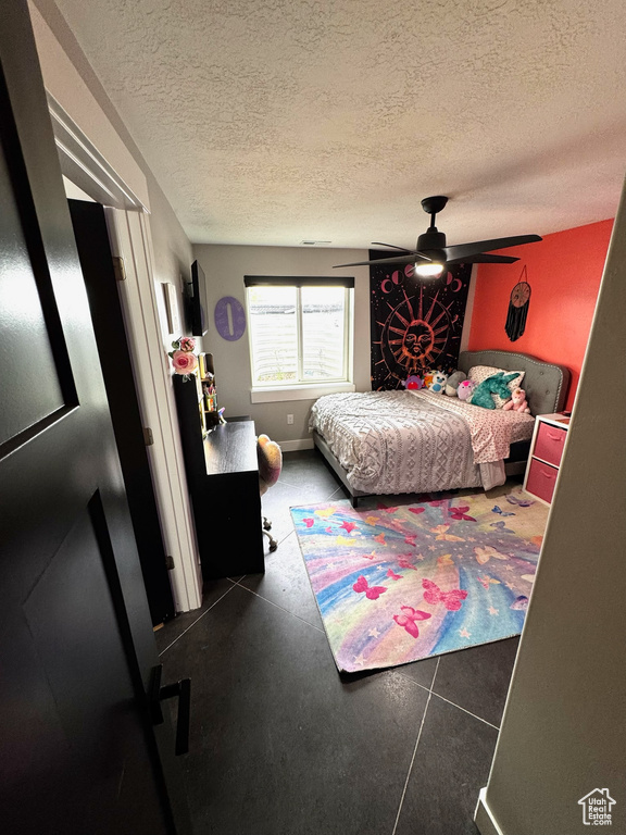Bedroom featuring a textured ceiling and a ceiling fan