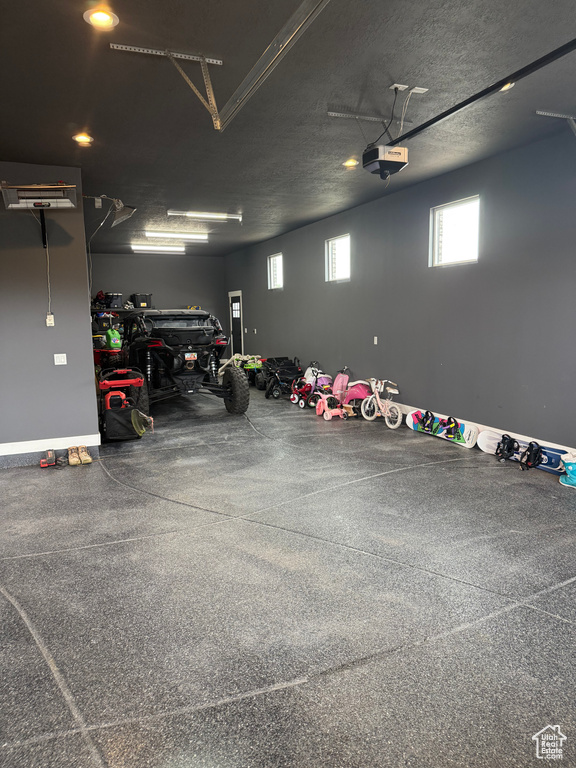 Garage with a garage door opener and baseboards