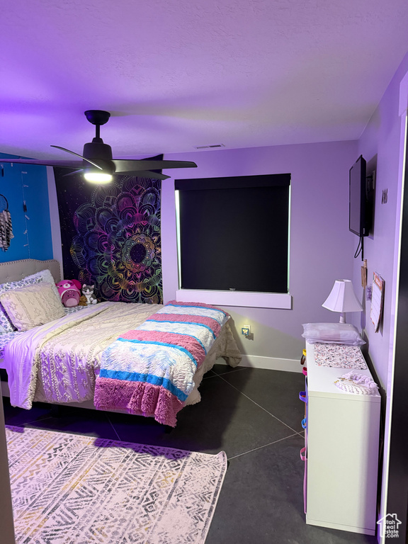 Bedroom with baseboards, ceiling fan, and visible vents
