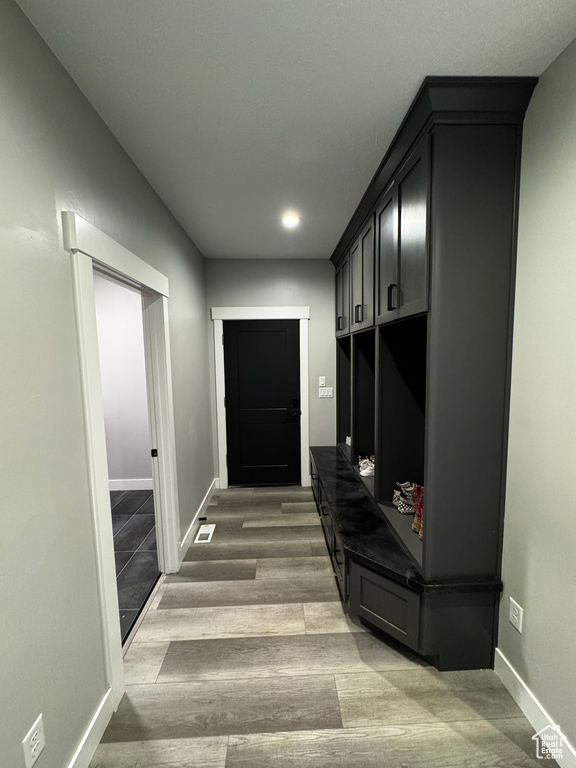 Mudroom with baseboards, wood finished floors, and recessed lighting