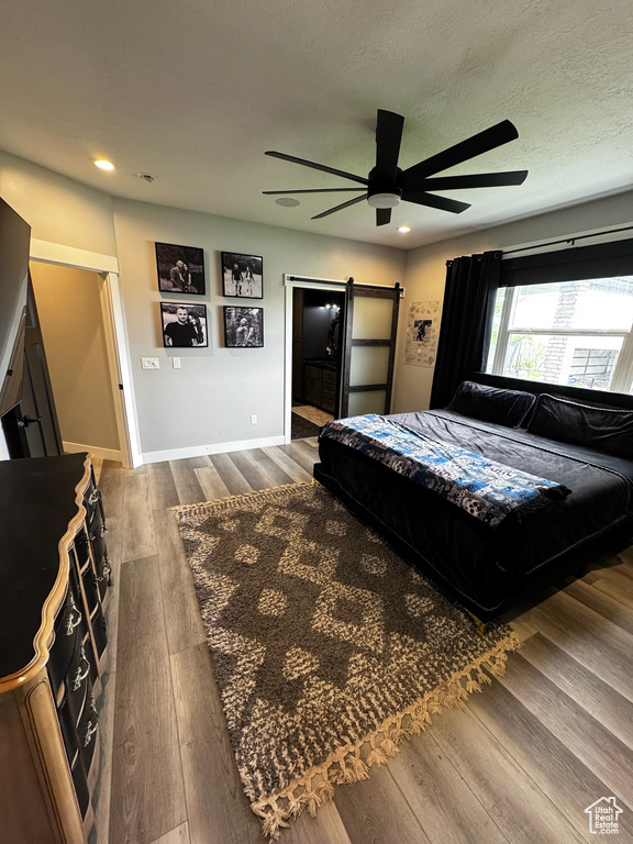 Bedroom with dark wood-type flooring, recessed lighting, baseboards, and ceiling fan