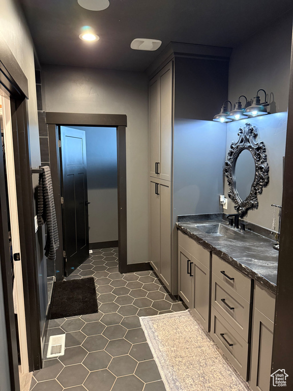Bathroom featuring visible vents, tile patterned flooring, and vanity