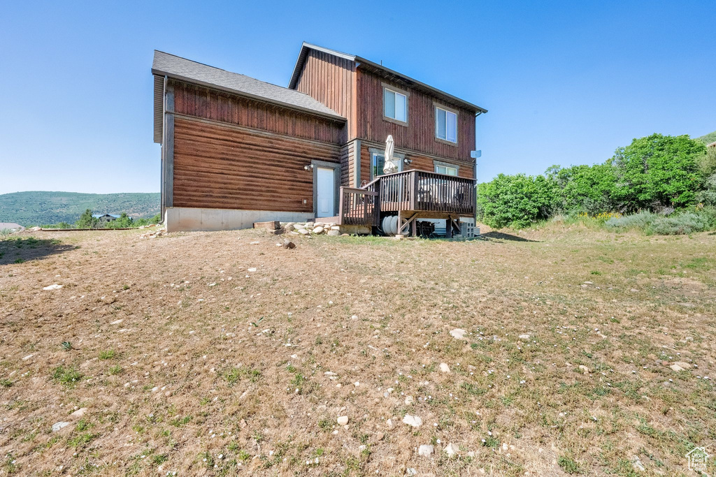 Back of house with a deck
