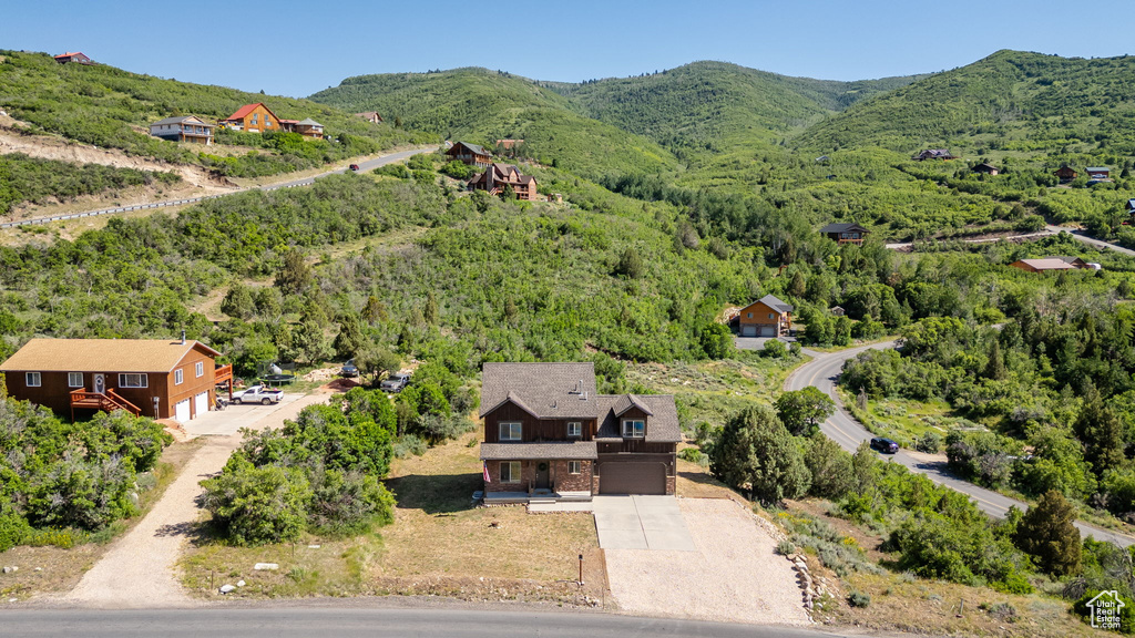 Aerial view of property and surrounding area featuring mountains