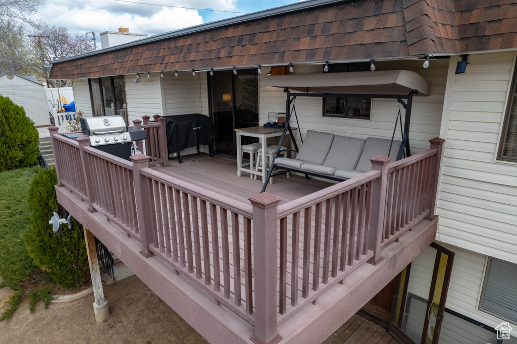 Wooden terrace with grilling area and outdoor lounge area
