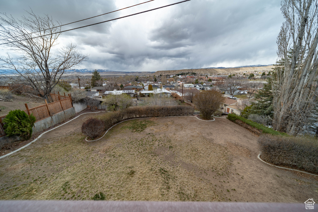 View of yard with fence and a mountain view