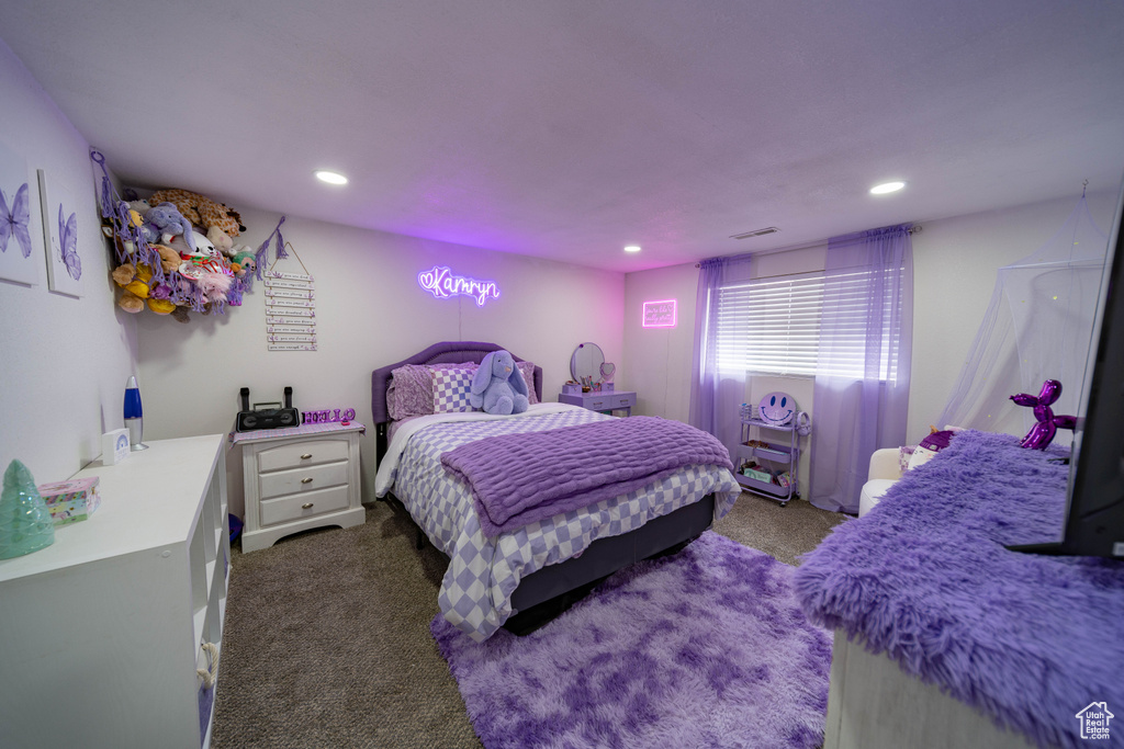 Bedroom with visible vents, dark carpet, and recessed lighting