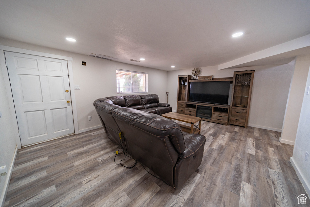 Living area with recessed lighting, baseboards, and wood finished floors