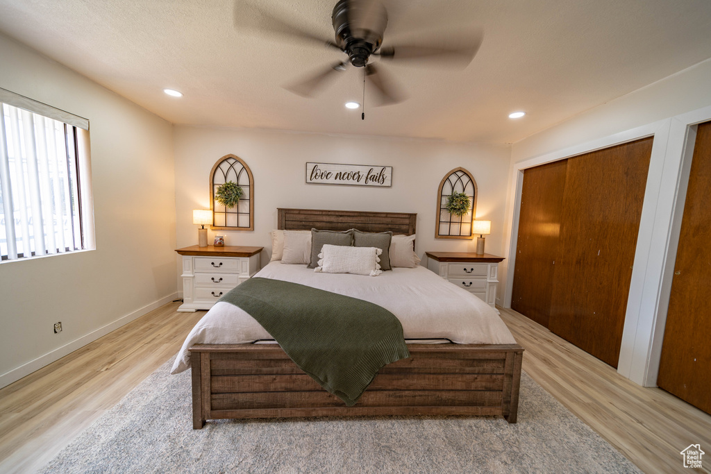 Bedroom featuring baseboards, light wood-type flooring, ceiling fan, and recessed lighting