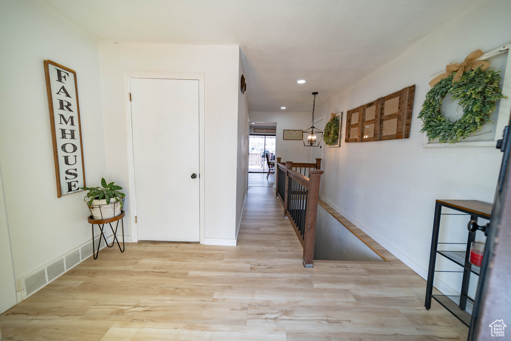 Hall featuring an upstairs landing, visible vents, light wood finished floors, baseboards, and recessed lighting