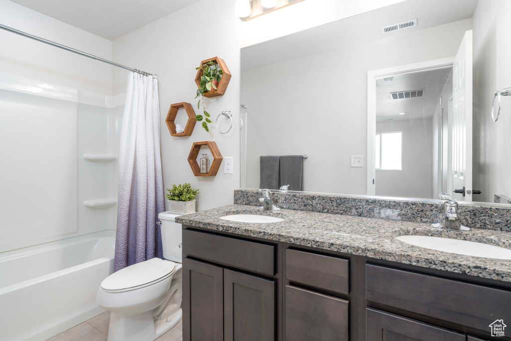 Bathroom with visible vents, toilet, and a sink