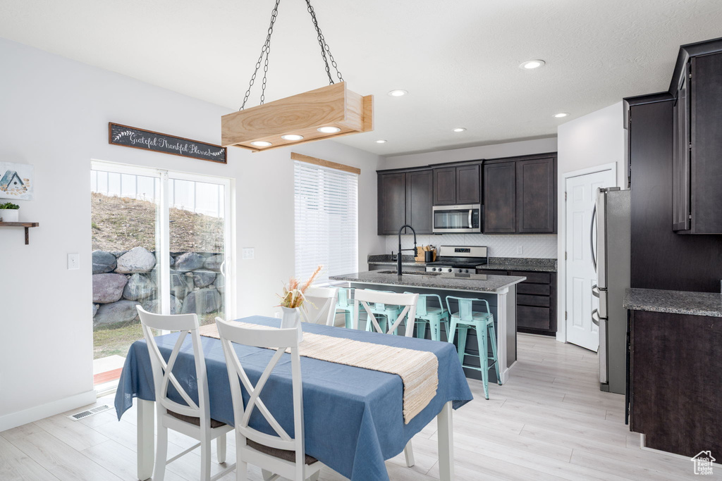 Dining area featuring baseboards, visible vents, recessed lighting, and light wood-type flooring
