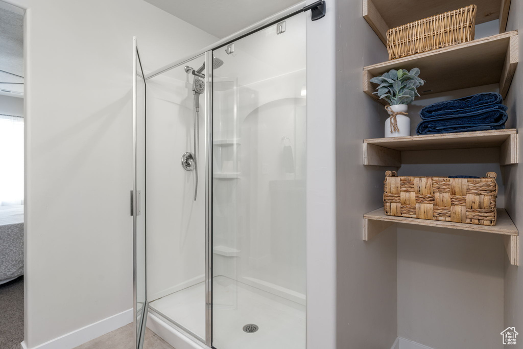 Full bathroom with baseboards and a shower stall