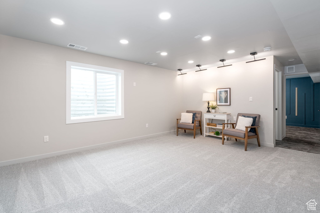 Sitting room featuring recessed lighting, light carpet, and visible vents