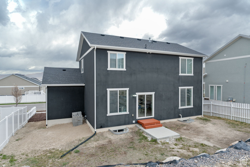 Rear view of property featuring a fenced backyard